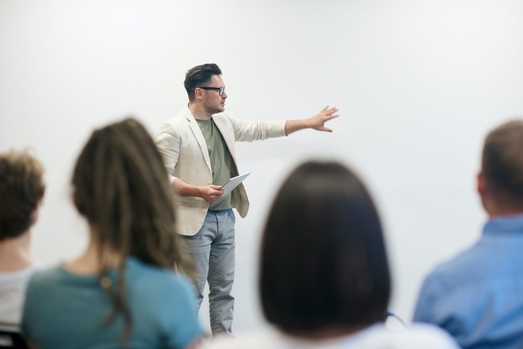 man presenting infront of room