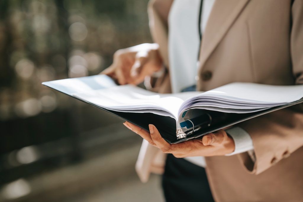 Woman holding folder with business documents