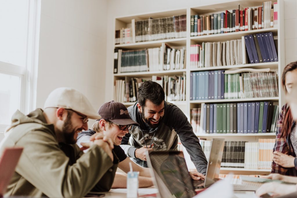 People laughing at work working on digital marketing campaign