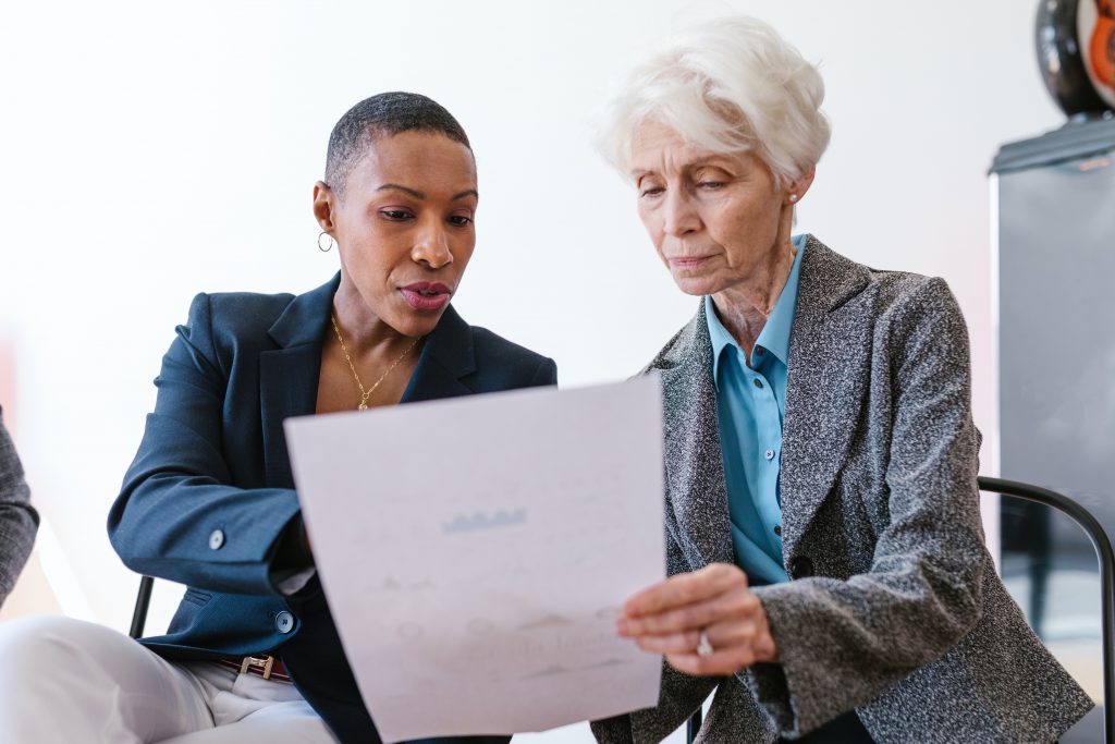 How to write a proposal for investors image two women reading paper