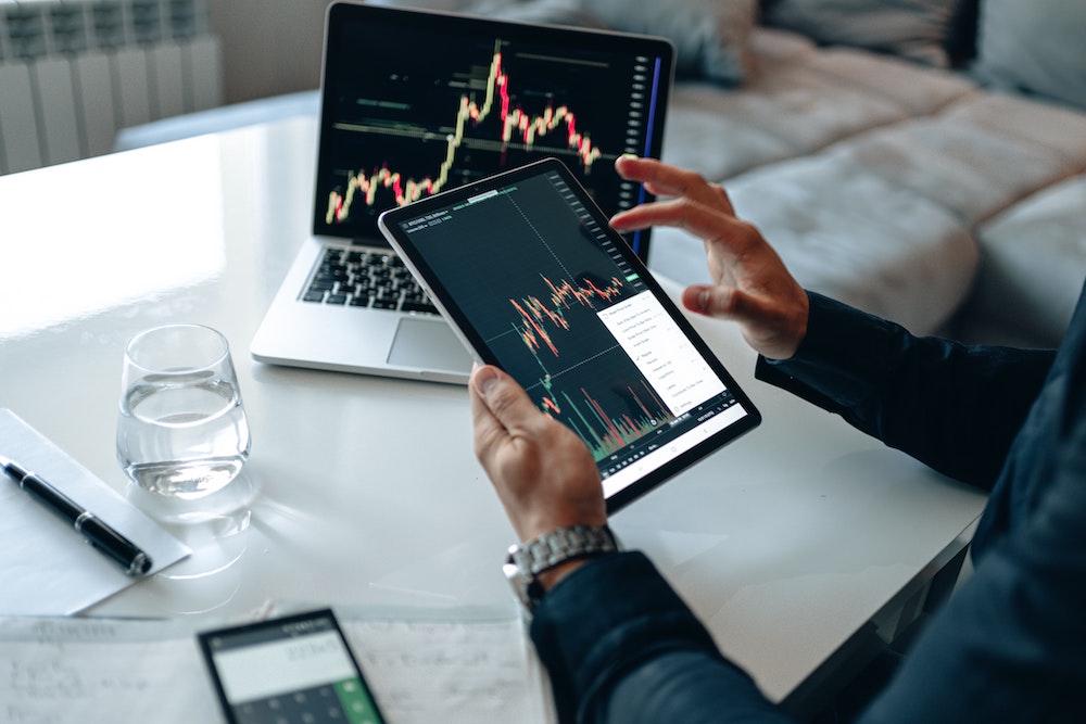 person with tablet studying charts